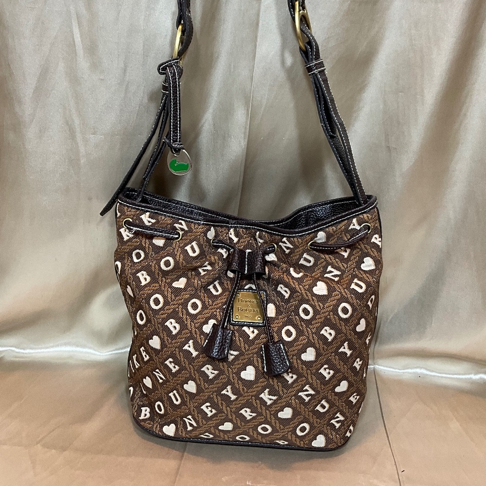 Dooney Burke bucket bag with signature brown & white print.   8-17-H7Aa